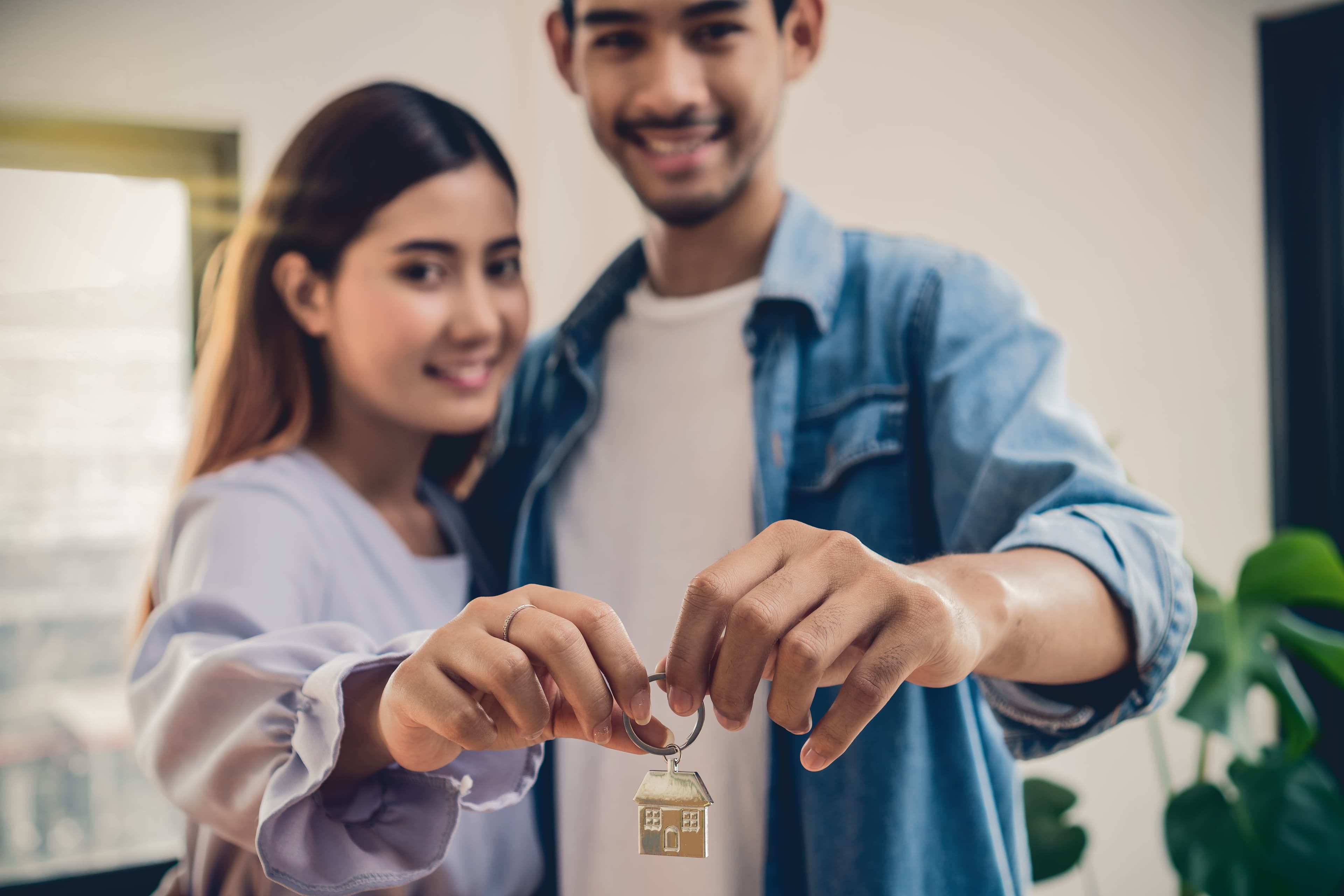 Couple holding a house key together