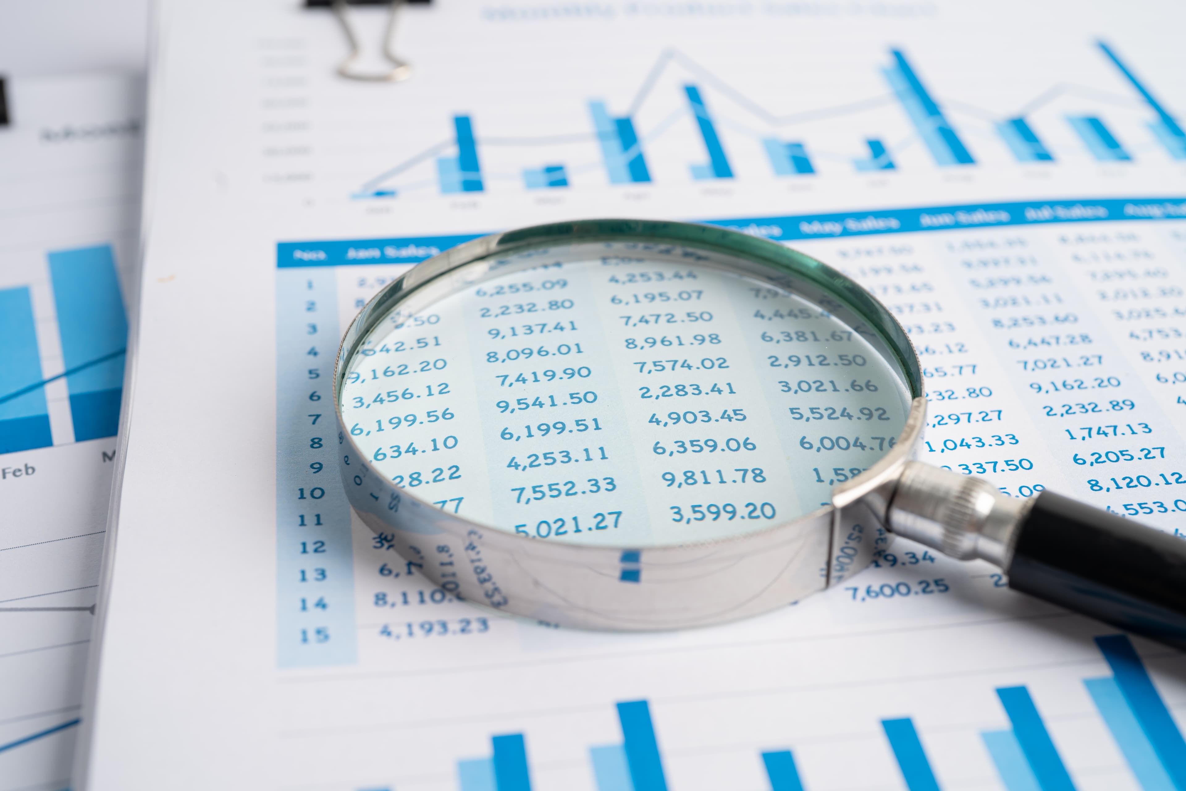 Magnifying glass on chart graph for analysis
