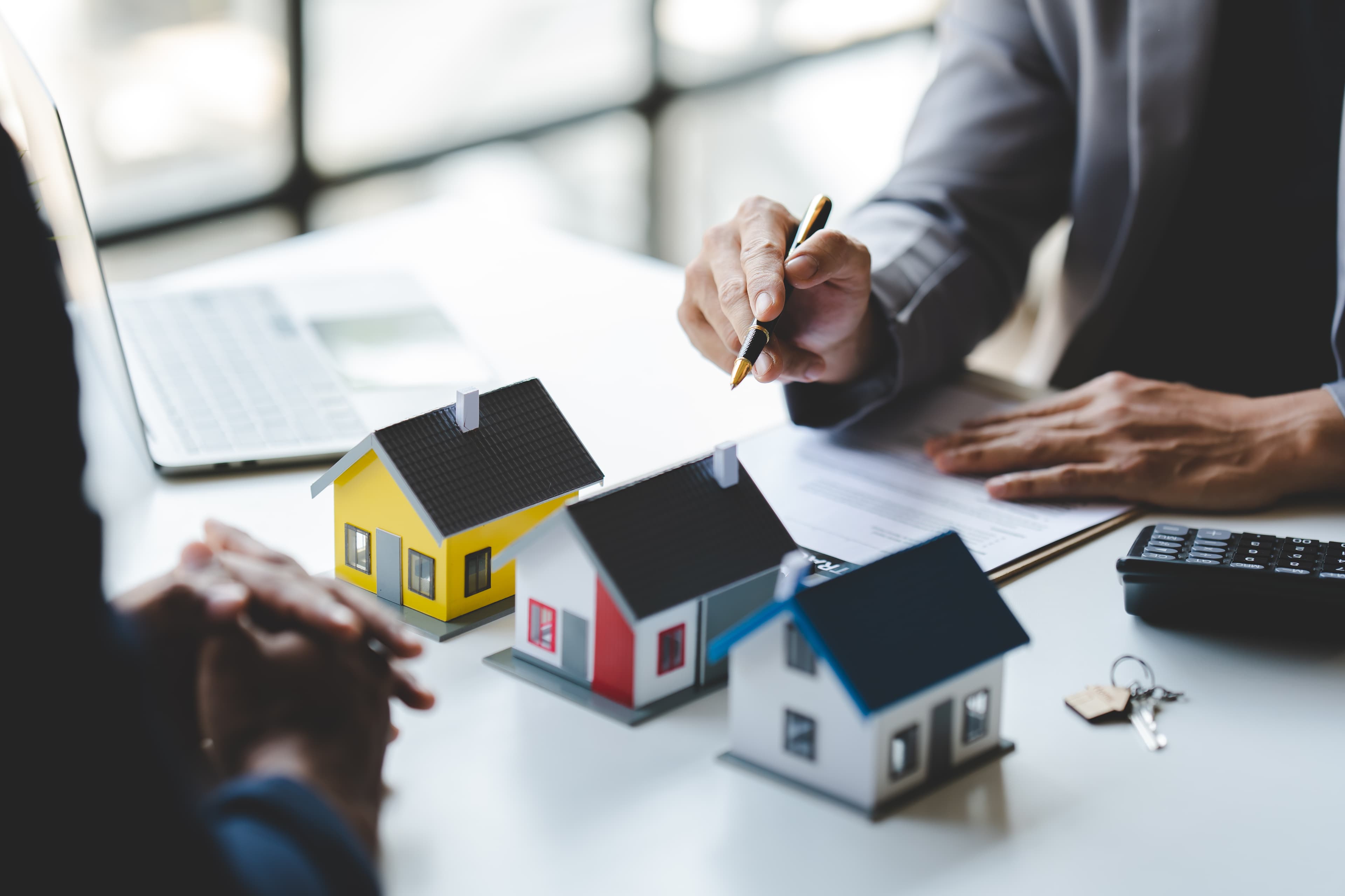 Real estate agent showing home model to customer