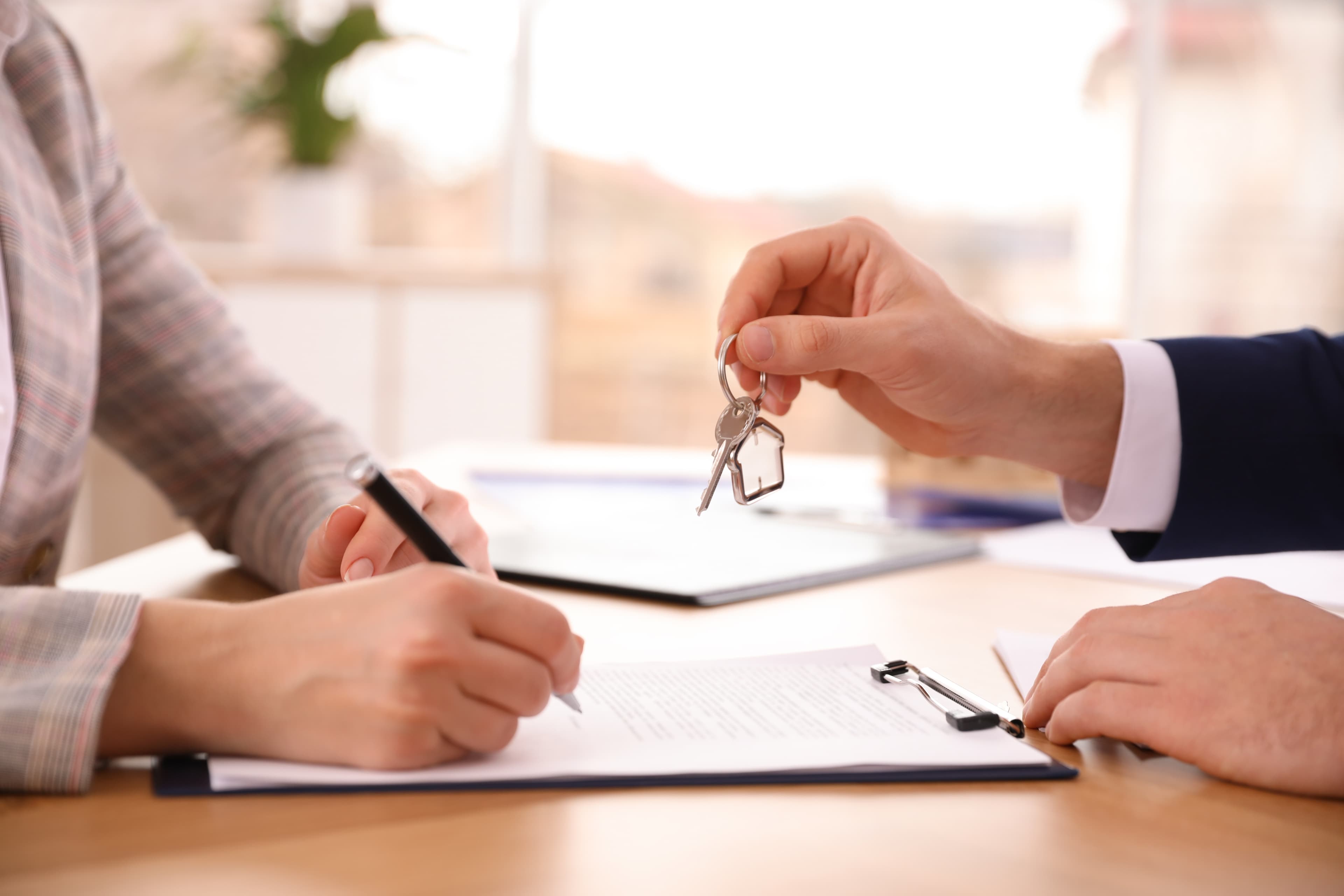 Agent handing over house keys to new resident