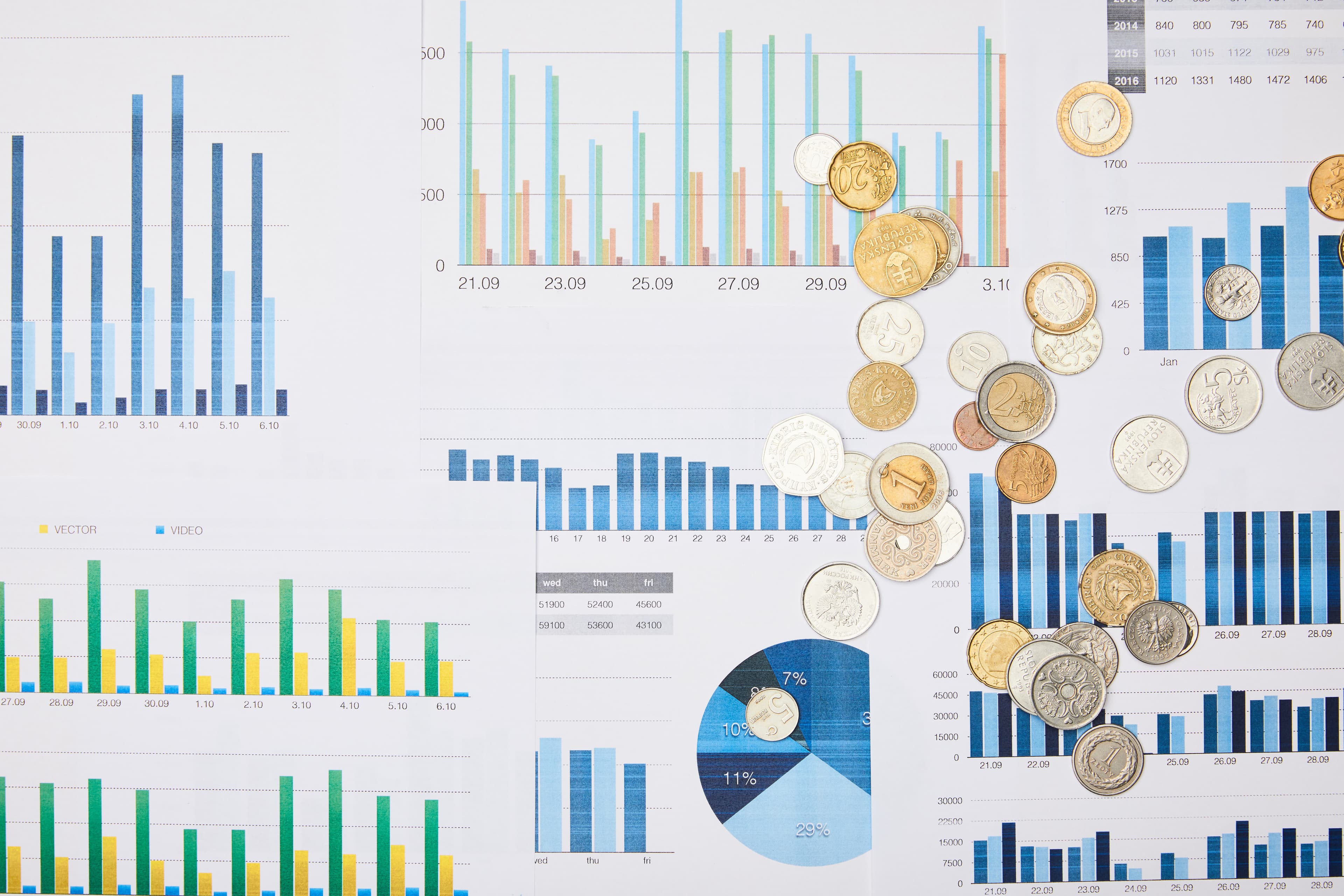 Financial papers with graphs and coins