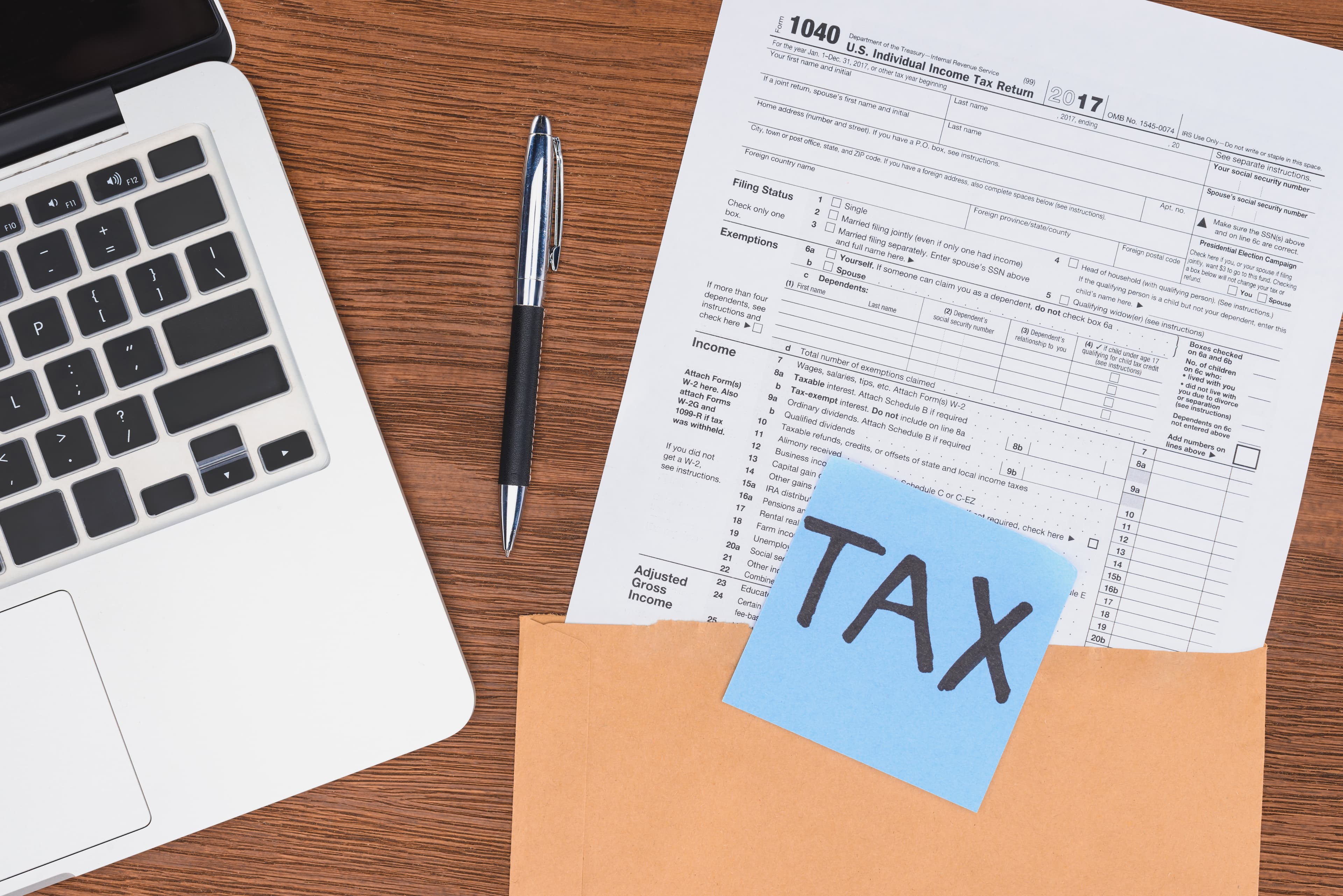 Tax form with laptop and card
